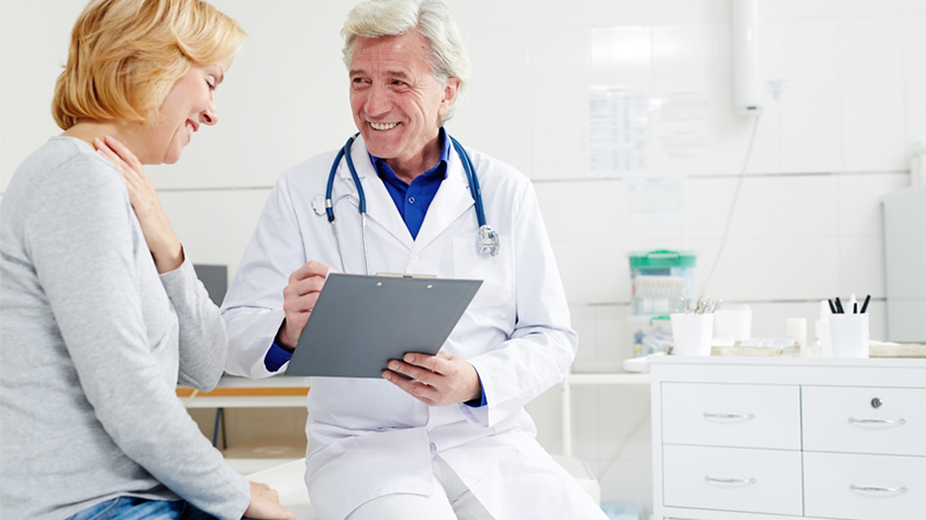 Male doctor sitting with patient