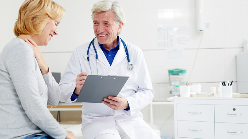 Male doctor sitting with patient