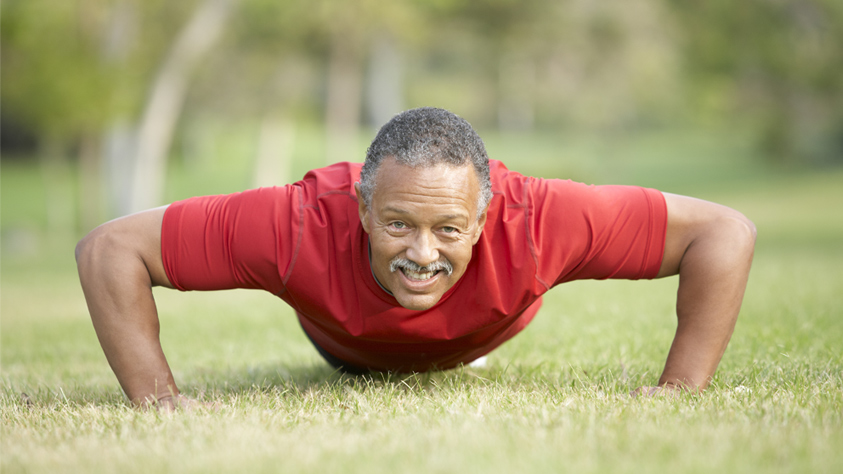 Male excersing on the grass