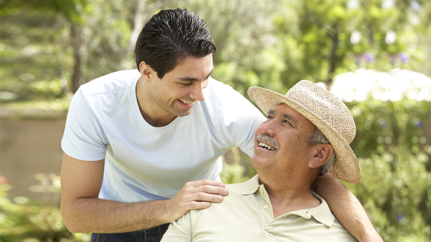 Male doctor sitting with patient